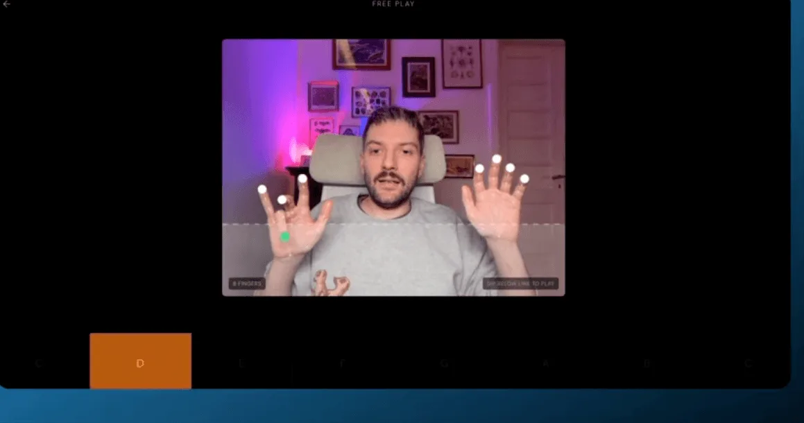 Web application interface showing hand tracking with finger markers and a musical note selection bar.